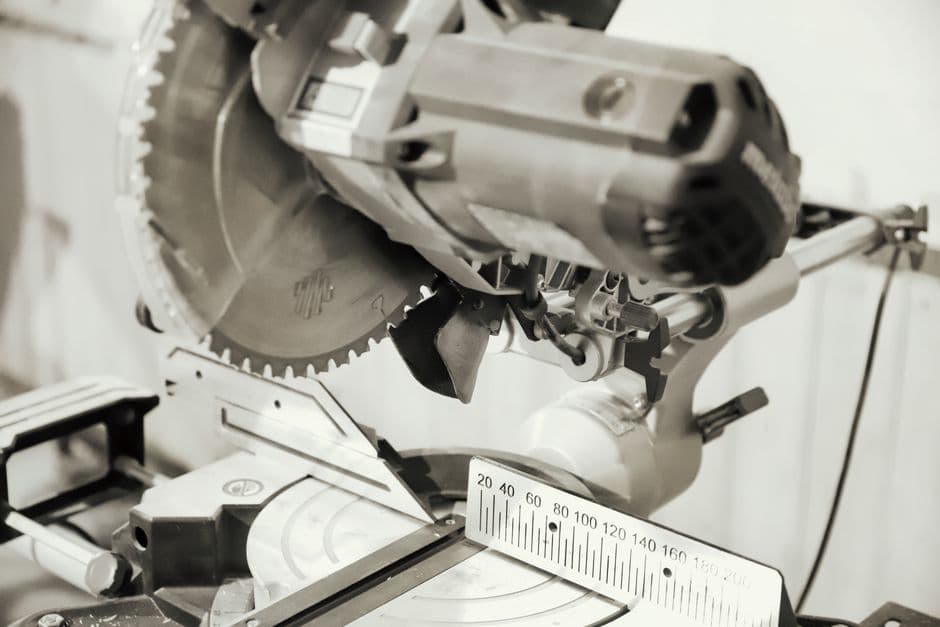 Close-up of a chop saw with its miter scale visible on the table