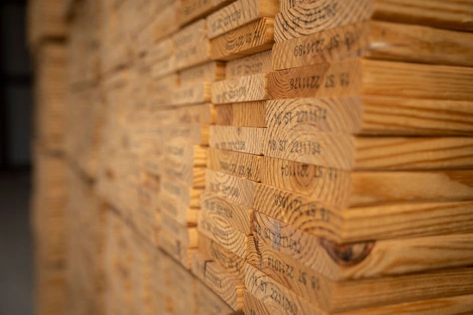 Close-up of a stack of hardwood lumber showing end grain and growth rings